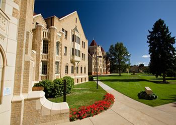 historic campus building with green lawn