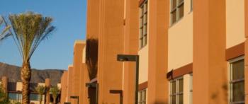 college dorm buildings under blue sky