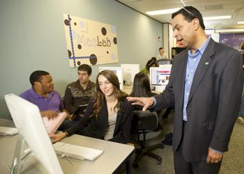 students and a teacher engaging in a computer lab