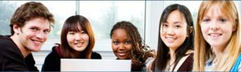 group of students with a laptop smiling at the camera