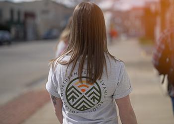 person with college of pennsylvania logo t-shirt