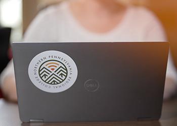 laptop with college of pennsylvania logo