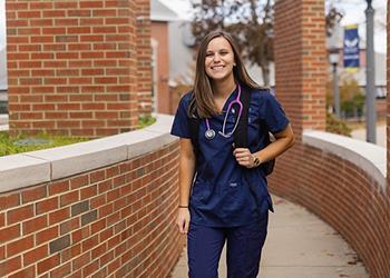 nursing student smiling in scrubs with stethoscope