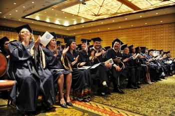 graduates sitting in a banquet hall during a ceremony