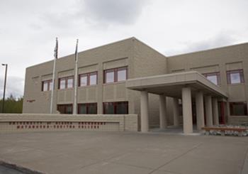 exterior of a modern educational building with flags