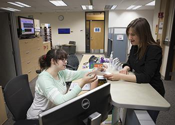 two people studying with anatomical model