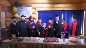 graduates posing at a celebration