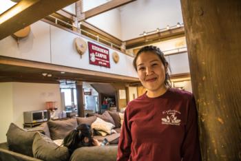 woman in maroon sweatshirt, 'ENGINEERING &amp; APPLIED SCIENCE' sign