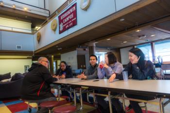 group at table beneath 'INVOLVEMENT &amp; LEADERSHIP' sign