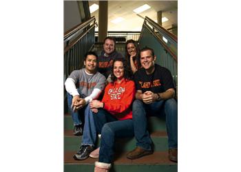 group of smiling students sitting on stairs